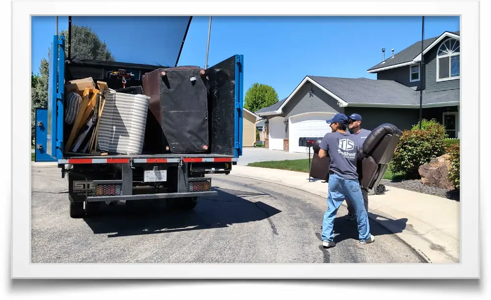 two mean load a truck with junk furniture
